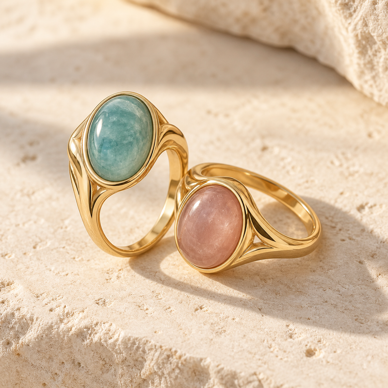 AI styling concept: blue-green and blush rings on a pale stone surface